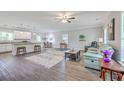 Open-concept living space features modern flooring, neutral walls, and seamless flow to dining and kitchen at 326 Turner Ln, Round O, SC 29474