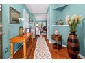 Bright and welcoming foyer with hardwood floors and decorative accents at 3312 Telford Ct, Summerville, SC 29485