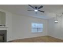 Bright living room features wood flooring, a fireplace, and a ceiling fan at 4028 Babbitt St, Charleston, SC 29414