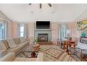 Cozy living room with a fireplace, hardwood floors, neutral colors, and comfortable seating at 4636 Ashley View Ln, North Charleston, SC 29405
