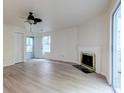 Inviting living room with a fireplace, ceiling fan, and sliding door to a screened-in porch at 6275 Rolling Fork Rd # 401, North Charleston, SC 29406