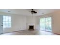 Living room with fireplace and natural light coming in through the sliding door and window at 6275 Rolling Fork Rd # 401, North Charleston, SC 29406