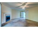 Cozy living room features a fireplace and ample natural light with a ceiling fan at 6280 Rolling Fork Rd # 302, North Charleston, SC 29406