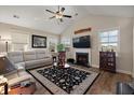 Cozy living room with a fireplace, hardwood floors, ceiling fan and a comfortable beige sectional sofa at 658 Yellow Leaf Ln, Summerville, SC 29486