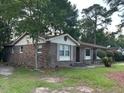 Brick single-story house with green grass yard and beautiful curb appeal at 8334 Witsell St, North Charleston, SC 29406