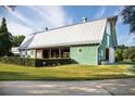 Exterior of the Community Barn with green siding, white trim and shed roof over outdoor area at 93 French Garden Cir, Summerville, SC 29486