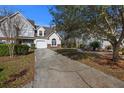 Inviting two-story home with a well-maintained lawn, garage, and a tree at 1005 Yellow Hawthorn Circle, Summerville, SC 29483