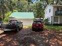 View showcasing the detached garage and driveway with a truck and SUV parked in front at 102 Webb St, Bonneau, SC 29431