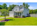Lovely home with verdant lawn, mature tree, and a two-car garage in a well-kept neighborhood at 104 Study Ct, Ladson, SC 29456