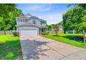 Traditional two-story home with a two-car garage, an ample lawn, and mature shade trees at 104 Study Ct, Ladson, SC 29456