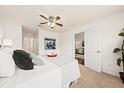 Cozy bedroom with ceiling fan, neutral tones, and view into the living room at 105 Brockman Way, Goose Creek, SC 29445