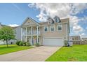 Charming two-story home featuring a welcoming front porch, attached two-car garage, and well-manicured lawn at 109 Cypress Plantation Rd, Moncks Corner, SC 29461