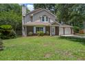 Attractive two-story home features a brick and vinyl exterior, a two-car garage and a well-manicured lawn at 110 Bayberry Run, Summerville, SC 29485