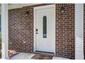 Front door with sidelight, brick surround, and modern lighting create a welcoming entry point at 110 Bayberry Run, Summerville, SC 29485