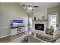 Living room features a cozy fireplace, vaulted ceilings, and abundant natural light at 112 Lewisfield Dr, North Charleston, SC 29418