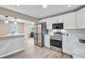Modern kitchen with stainless steel appliances, quartz countertops, and sleek white cabinets at 113 Harvey Ave, Goose Creek, SC 29445