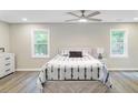 Spacious main bedroom with a ceiling fan, wood flooring, and lots of natural light at 113 Harvey Ave, Goose Creek, SC 29445