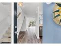 View of the foyer with wooden floors, staircase, decor and view of backyard through sliding doors at 1136 Shadow Lake Cir, Mount Pleasant, SC 29464