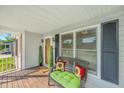 Inviting covered front porch with seating, decor, and a view of the home's entrance at 115 W Park Ln, Summerville, SC 29486