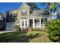 Beautiful home with an inviting front porch, attached garage, and lush green lawn at 116 Marshside Dr, Summerville, SC 29485