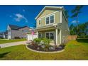 Well-maintained two-story home featuring manicured landscaping and inviting curb appeal on a sunny day at 119 Lucca Dr, Summerville, SC 29486