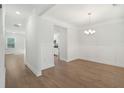 Bright, open-concept dining room with hardwood floors, modern lighting, and elegant wall paneling at 1216 Ashley Hall Rd, Charleston, SC 29407