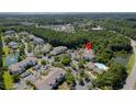 Aerial view of a residential community with multiple buildings, surrounded by lush greenery and bodies of water at 1300 Park West Blvd # 106, Mount Pleasant, SC 29466