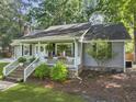 View of a quaint single-story home with a welcoming front porch, brick steps, and a well-maintained lawn at 1337 Old Fort Rd, Moncks Corner, SC 29461
