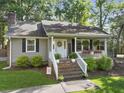 Charming home featuring a welcoming front porch, brick stairs, and beautifully landscaped front yard with mature trees at 1337 Old Fort Rd, Moncks Corner, SC 29461