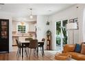 An open dining room adjacent to the kitchen featuring a modern table set and sliding door to backyard at 1350 Water Edge Dr, Charleston, SC 29492