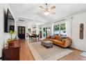 Bright living room with wood floors, a ceiling fan, and large windows offering natural light at 1350 Water Edge Dr, Charleston, SC 29492