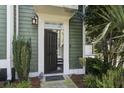 Welcoming front entrance with a dark-colored front door, sidelight, and a well-manicured garden at 136 Heart Pine Cir, Summerville, SC 29485