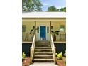 Inviting front entrance features a vibrant blue door, wooden steps, porch, and well-maintained landscaping at 1515 N Lakeshore Dr, Mount Pleasant, SC 29466