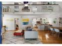 Bright, open-concept living room with vaulted ceilings, hardwood floors, and stylish contemporary furnishings at 1515 N Lakeshore Dr, Mount Pleasant, SC 29466