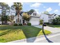 Well-maintained two-story home with a lush green lawn and an inviting, neatly paved driveway at 2050 S Smokerise Way, Mount Pleasant, SC 29466