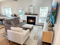 Inviting living room with a cozy fireplace, comfortable seating, and lots of natural light at 2050 S Smokerise Way, Mount Pleasant, SC 29466