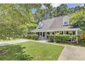Charming single Gathering home with a well maintained front yard, mature trees, and a long driveway at 2136 Kings Gate Ln, Mount Pleasant, SC 29466