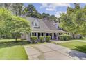Charming single Gathering home with a well maintained front yard, mature trees, and a long driveway at 2136 Kings Gate Ln, Mount Pleasant, SC 29466
