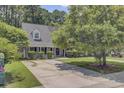 Charming single Gathering home with a well maintained front yard, mature trees, and a long driveway at 2136 Kings Gate Ln, Mount Pleasant, SC 29466