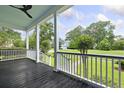Spacious porch featuring a dark-stained wood floor and a painted ceiling, offering a relaxing outdoor space at 2258 Arthur Gaillard Ln, Charleston, SC 29414