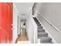 Bright entryway showcasing stairs, wood floors, and a door leading to the outside, creating a welcoming transition at 2362 Parsonage Rd # 2H, Charleston, SC 29414