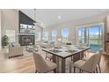 Open-concept living and dining area featuring hardwood floors, fireplace, modern furnishings and plenty of natural light at 240 Lucca Dr, Summerville, SC 29486
