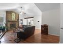 Spacious living room with a stone fireplace, hardwood floors, and lots of natural light at 2831 Chicopee Dr, North Charleston, SC 29420