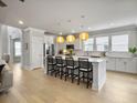 Bright kitchen with a large island, pendant lighting, stainless steel appliances, and hardwood floors at 2889 Backman St, Mount Pleasant, SC 29466