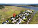 Aerial view of coastal home with marsh and river surroundings at 3095 S Shore Dr, Charleston, SC 29407