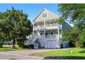 Two-story coastal style home with dual balconies and white railings at 3095 S Shore Dr, Charleston, SC 29407