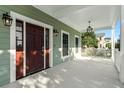 Inviting front porch with wooden door and lantern-style lighting at 3095 S Shore Dr, Charleston, SC 29407