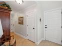 Hallway with neutral walls, tile floors, detailed trim, and white doors at 3616 Bagley Dr, Mount Pleasant, SC 29466