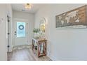 Bright foyer featuring wood floors, decorative table, and stylish decor, creating a welcoming entrance at 4314 Cotton Flat Rd, Summerville, SC 29485