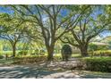 Landscaped front yard with mature trees, hedges, and gated entry at 4428 Maple Ridge Rd, Walterboro, SC 29488